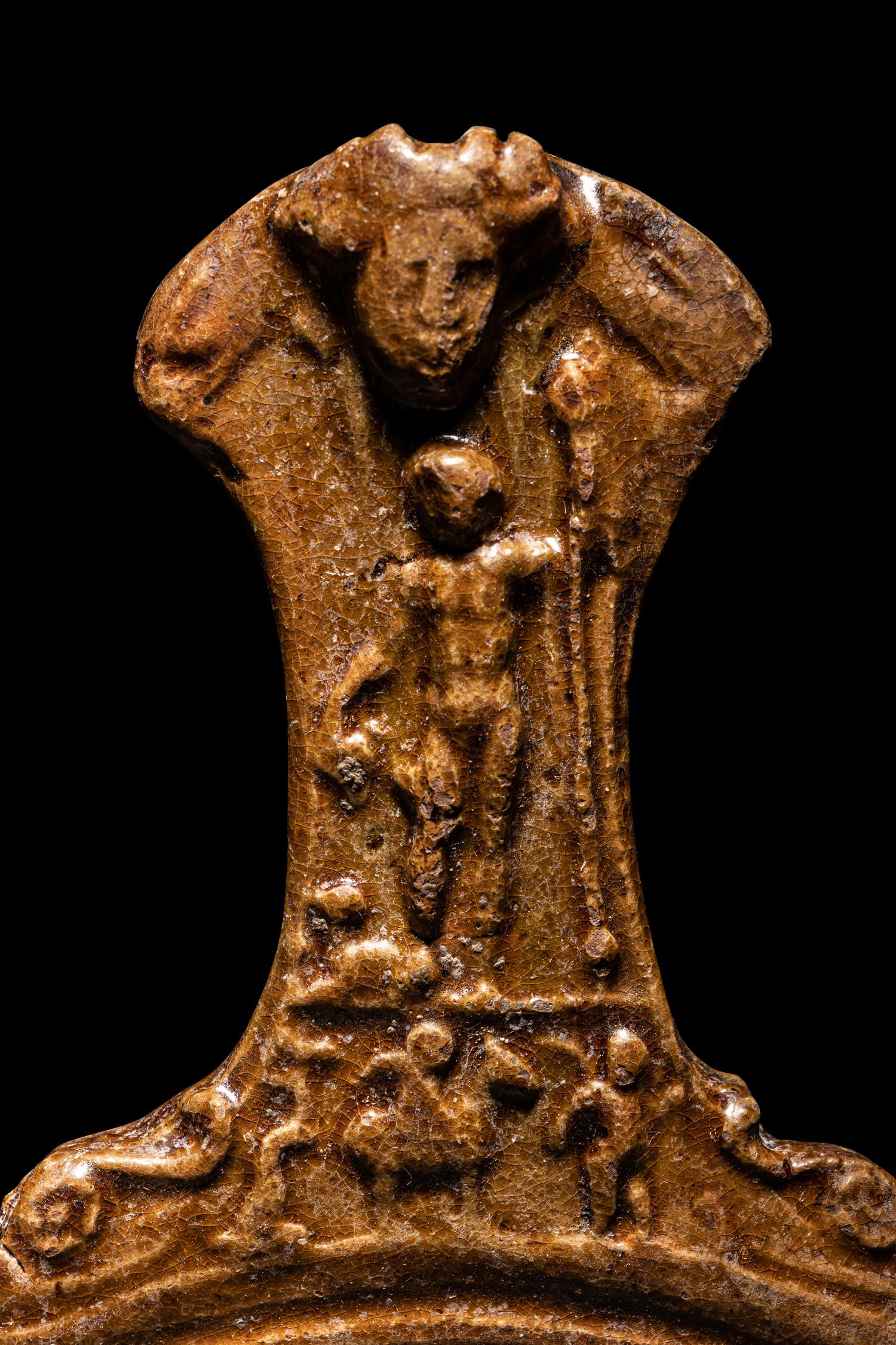 A Hellenistic Molded Glazed Pottery Handle