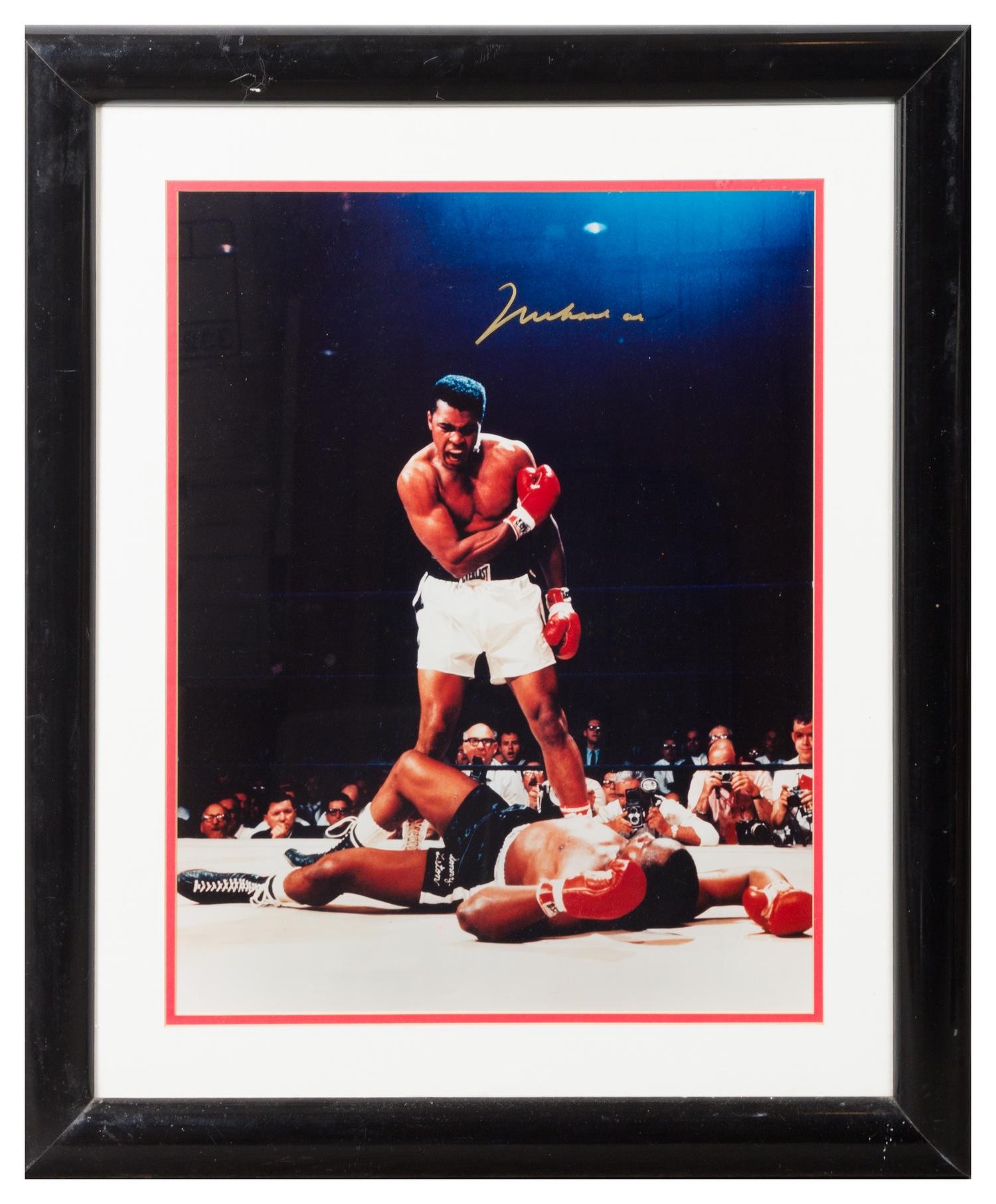 A Muhammad Ali Autographed Photo 19 x 15 inches visible.