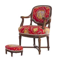A Louis XVI Style Carved Armchair and Stool with Fortuny Upholstery