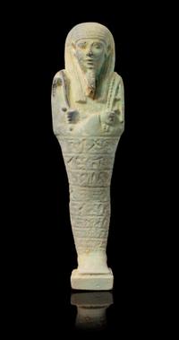 An Egyptian Faience Shabti Height 9 1/2 inches. — LATE PERIOD, DYNASTY 26, 664-525 B.C.E.