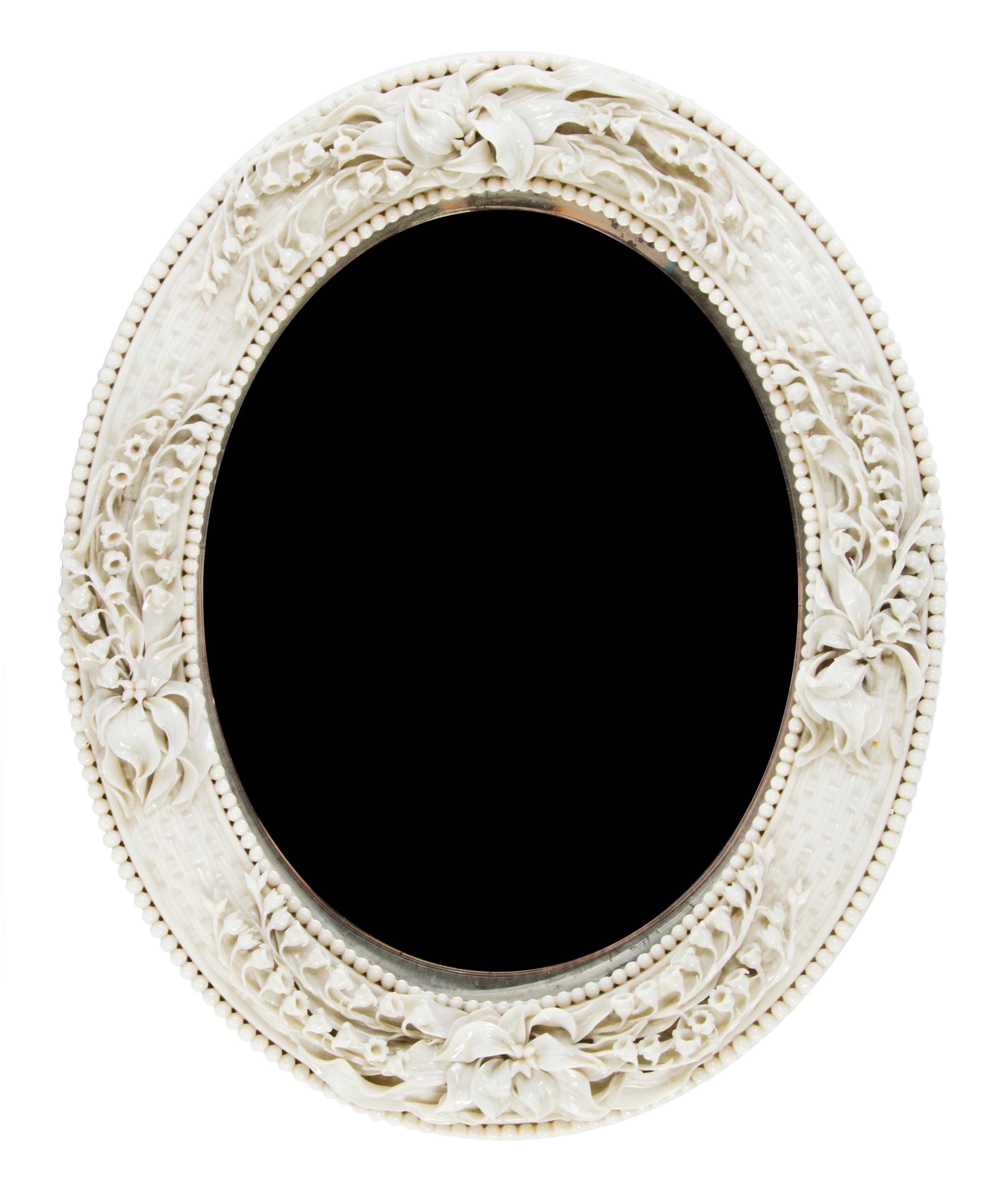 A Belleek Lily of the Valley Mirror, Height 16 x width 13 inches.