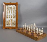A Chinese Carved and Stained Ivory Chess Set, Height of largest figure 5 inches.