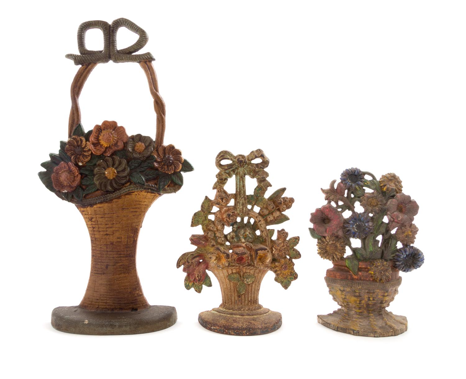 Three Victorian Cast Iron Doorstops Height of tallest 18 inches.