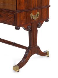 A Regency Style Figured Rosewood Double-Sided Bookcase on Stand