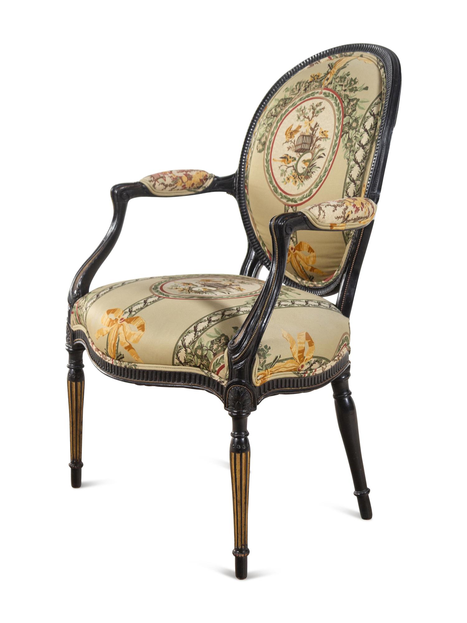 A George III Style Parcel Gilt and Ebonized Armchair
