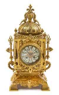 A Continental Neoclassical Style Brass Mantel Clock Height 18 x width 8 1/2 x depth 6 inches. — CIRCA 1900