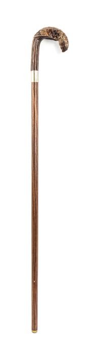 A Carved Wood Cane, Length of handle 5 1/4 x length overall 35 3/4 inches.
