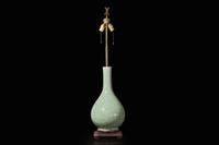 A Chinese carved celadon-glaze porcelain vase, mounted as a lamp 青釉賞瓶改製檯燈