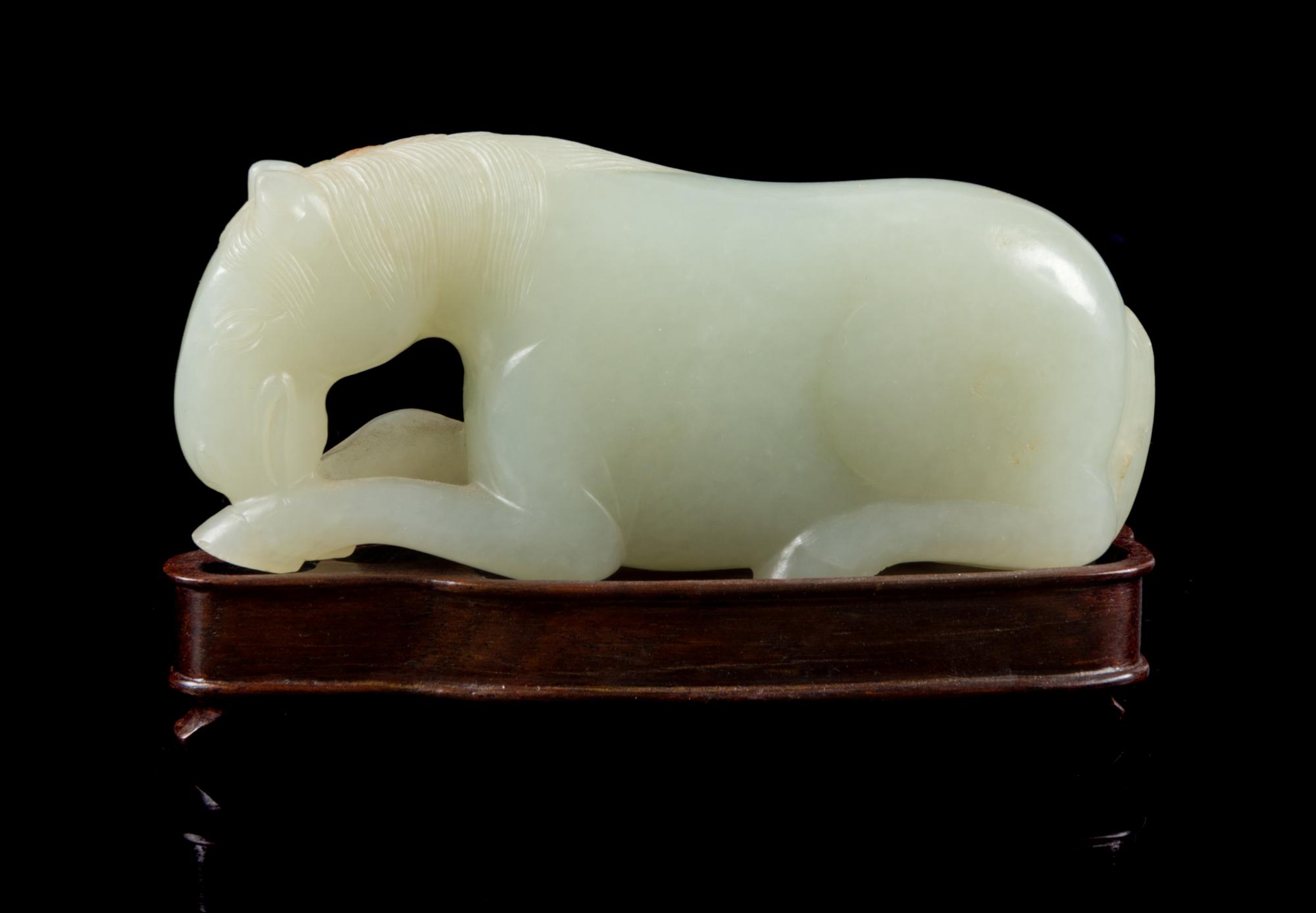 A Carved White Jade Figure of a Horse Length 3 3/4 inches. — 19TH CENTURY