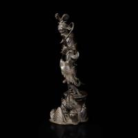 A patinated bronze figure of a Daoist immortal with crane 道教仙人与鹤铜塑 17th century ????