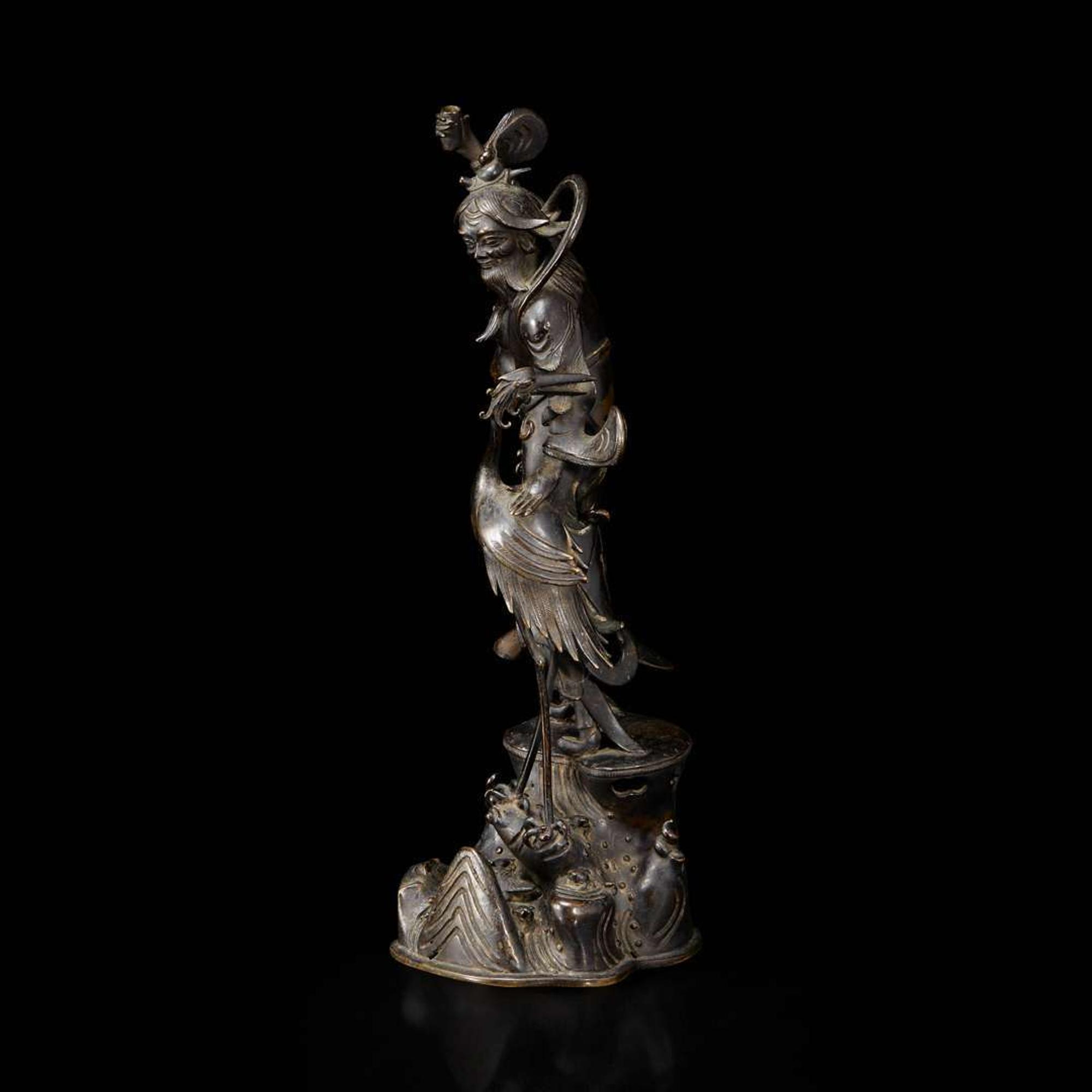 A patinated bronze figure of a Daoist immortal with crane 道教仙人与鹤铜塑 17th century ????