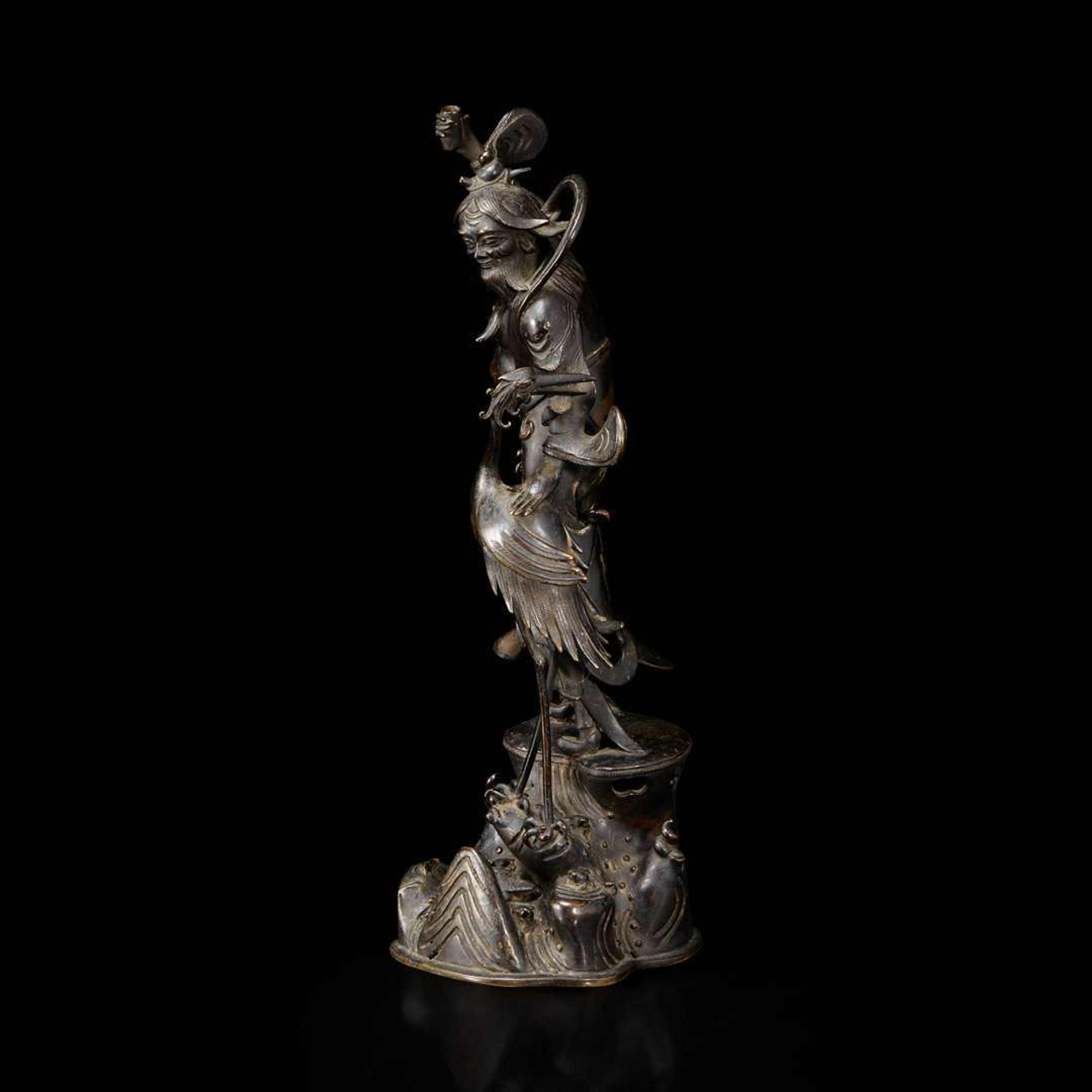 A patinated bronze figure of a Daoist immortal with crane 道教仙人与鹤铜塑 17th century ????