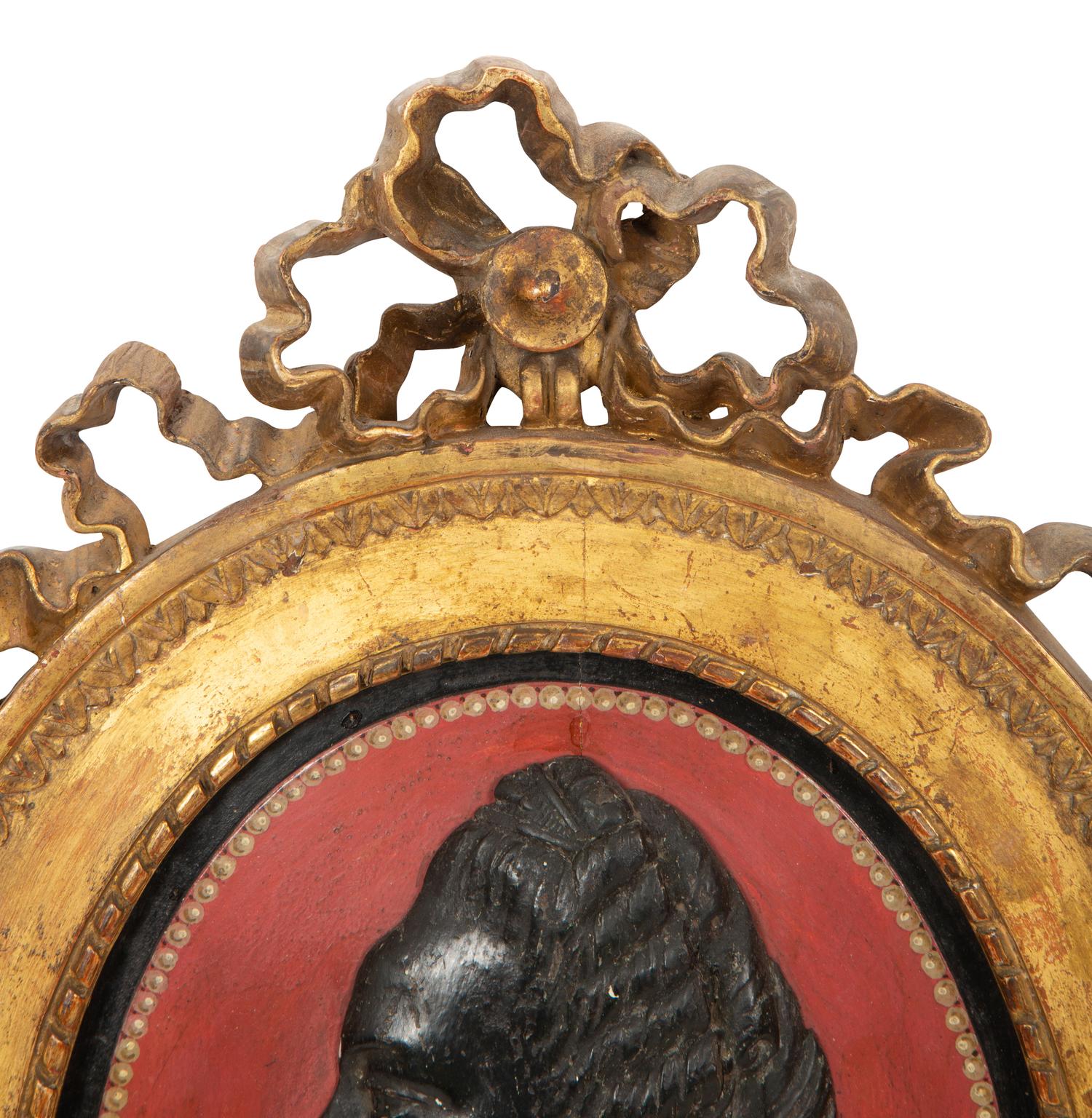 A Pair of Giltwood Framed Ebonized Relief Portrait Plaques of French Nobility, 18th Century