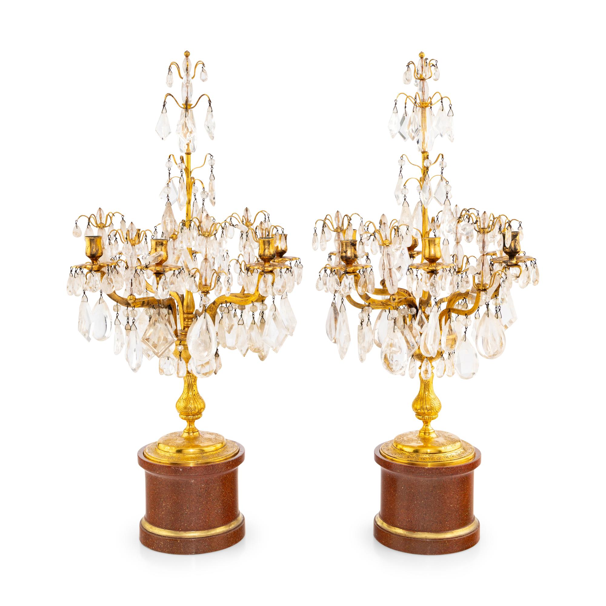 A Pair of Régence Style Rock Crystal, Cut Glass and Engraved Gilt Bronze Six-Light Candelabra on Simulated Porphyry Bases