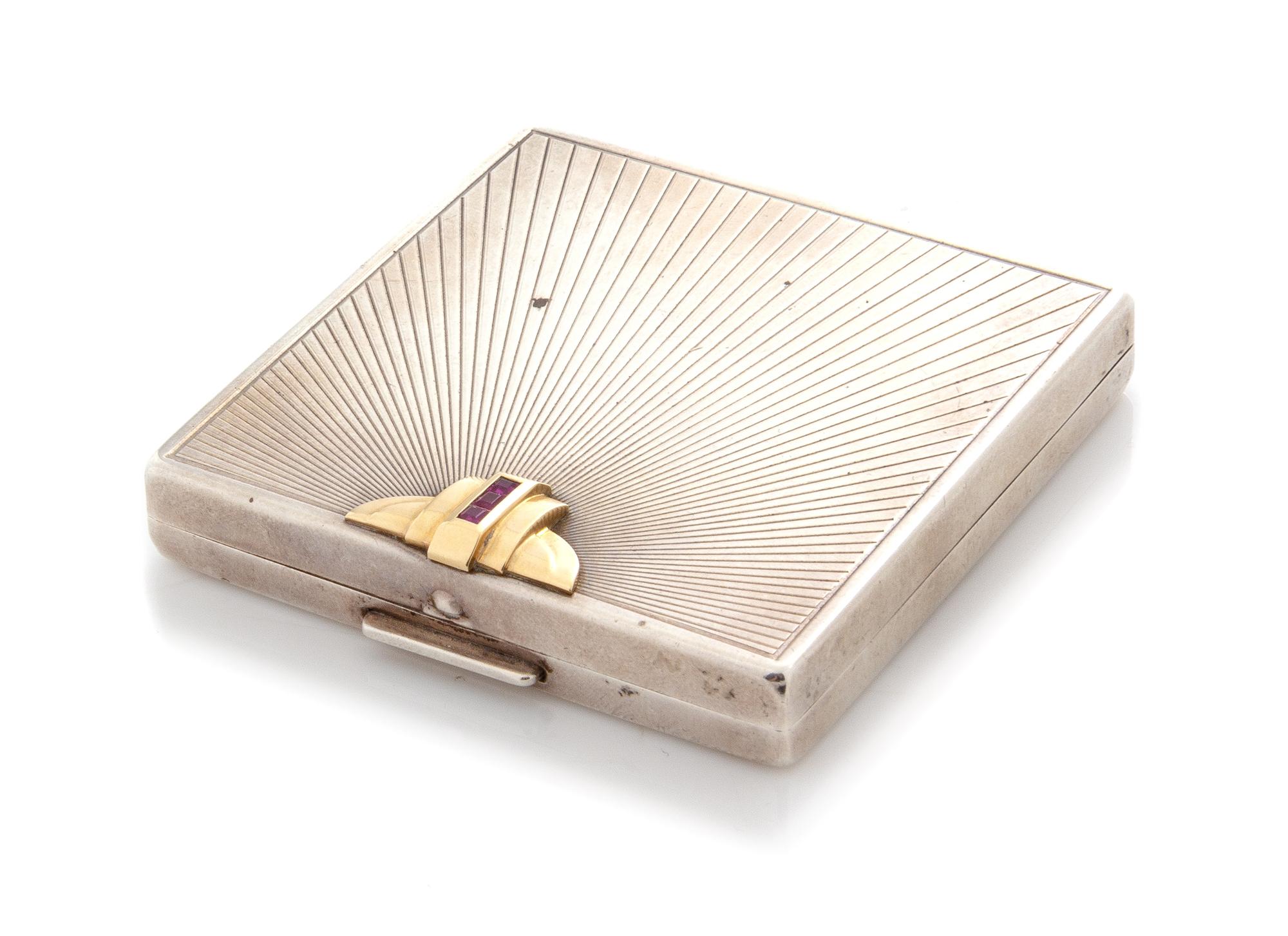An American Silver 14-Karat Gold and Ruby Inset Compact, Maker's Mark WAB, First Half 20th Century, the lid with a gold and ruby appliq