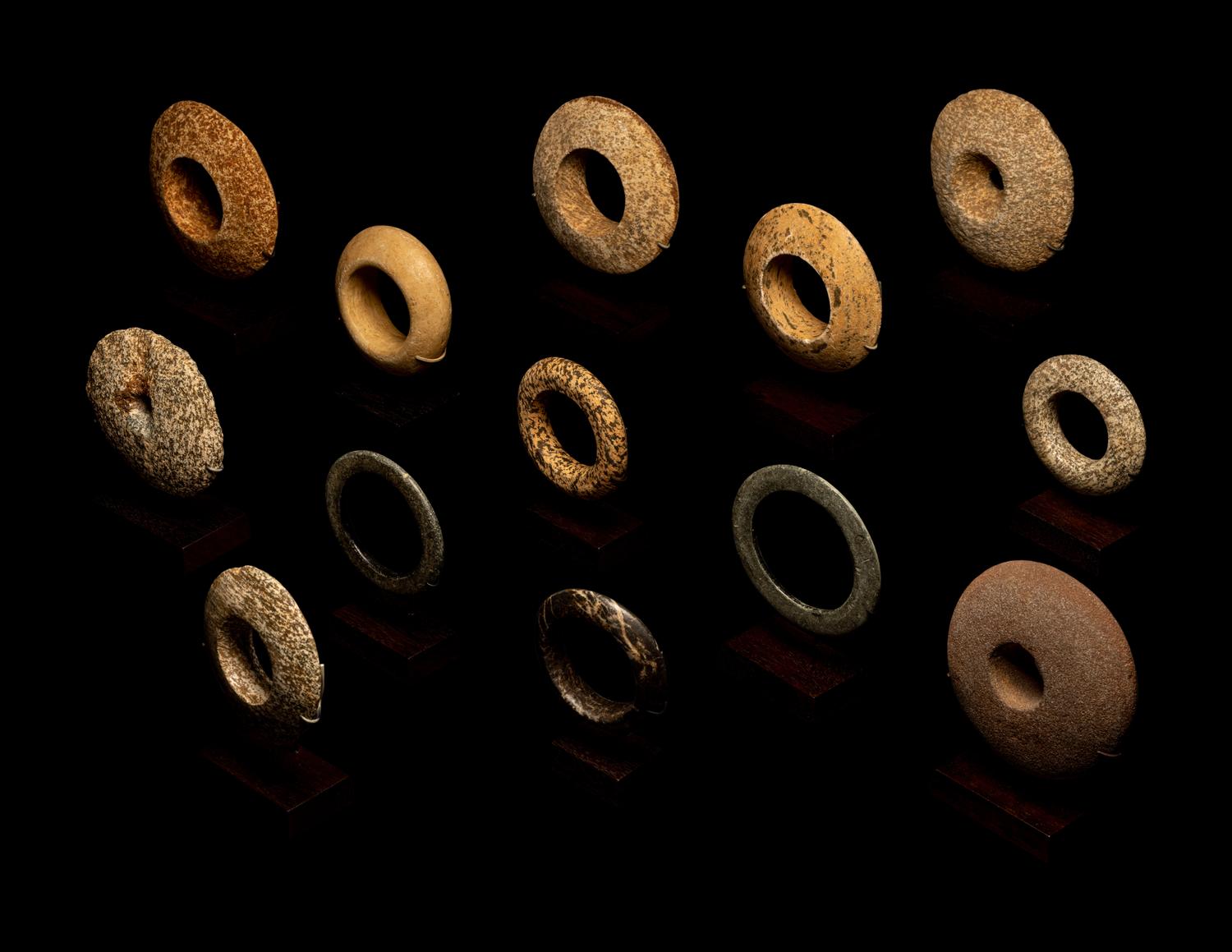 Thirteen Saharan Stone Bracelets and Discoidals