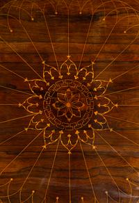 A Charles X Line Inlaid Rosewood Center Table with Marquetry Depicting Suits of Armor
