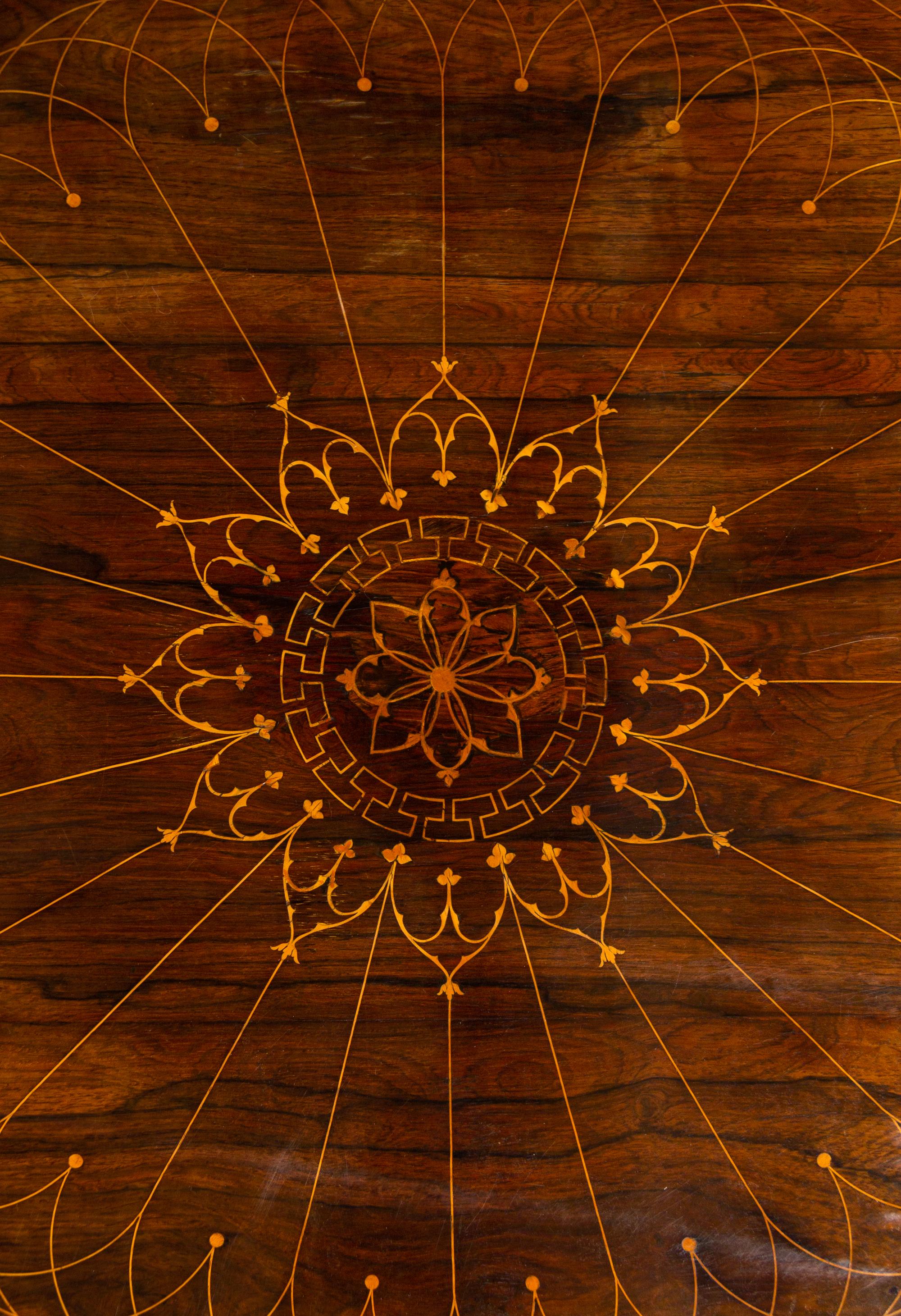 A Charles X Line Inlaid Rosewood Center Table with Marquetry Depicting Suits of Armor