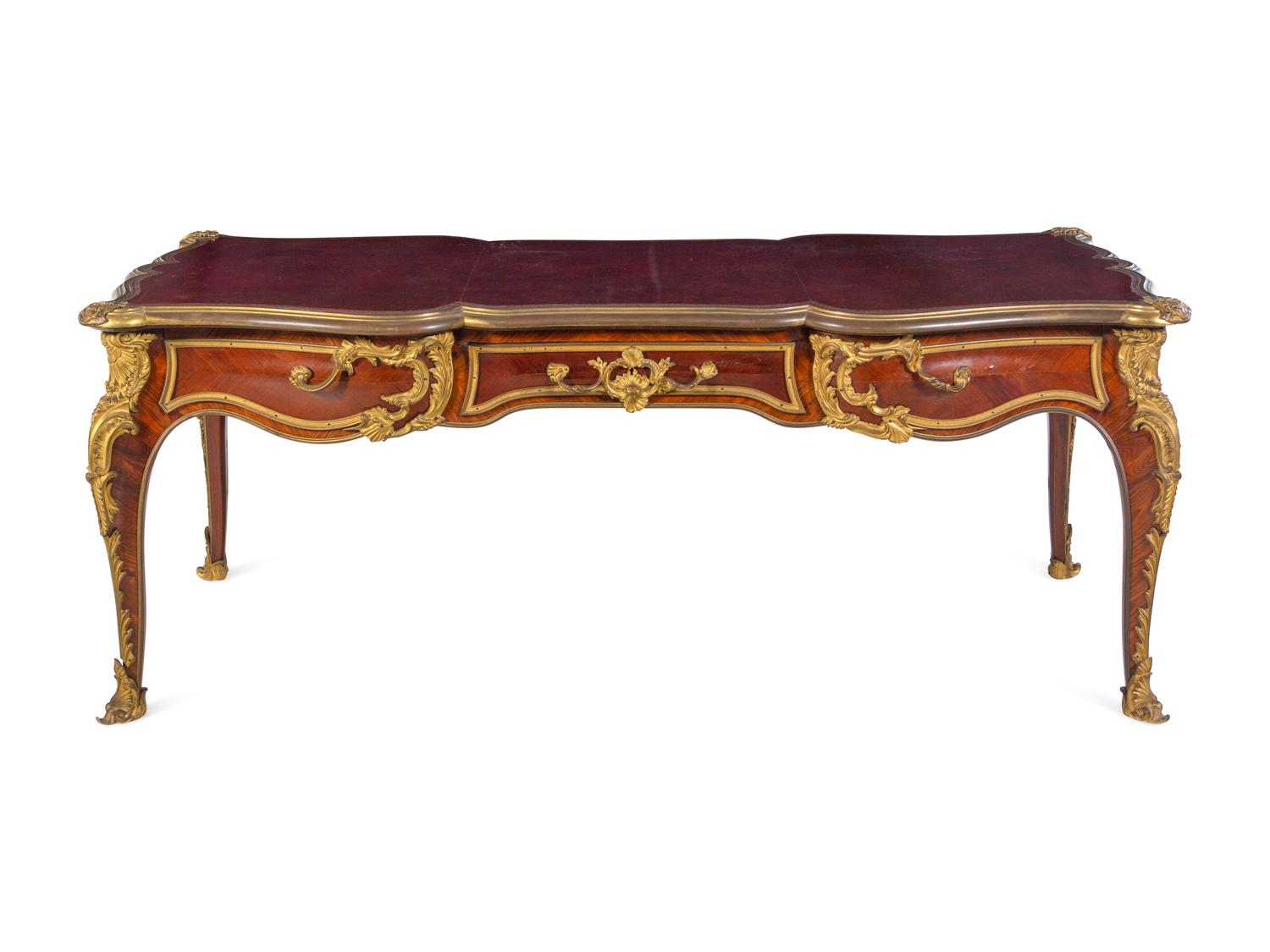 A Louis XV Style Gilt Bronze Mounted and Tooled Leather-Inset Tulipwood Bureau Plat