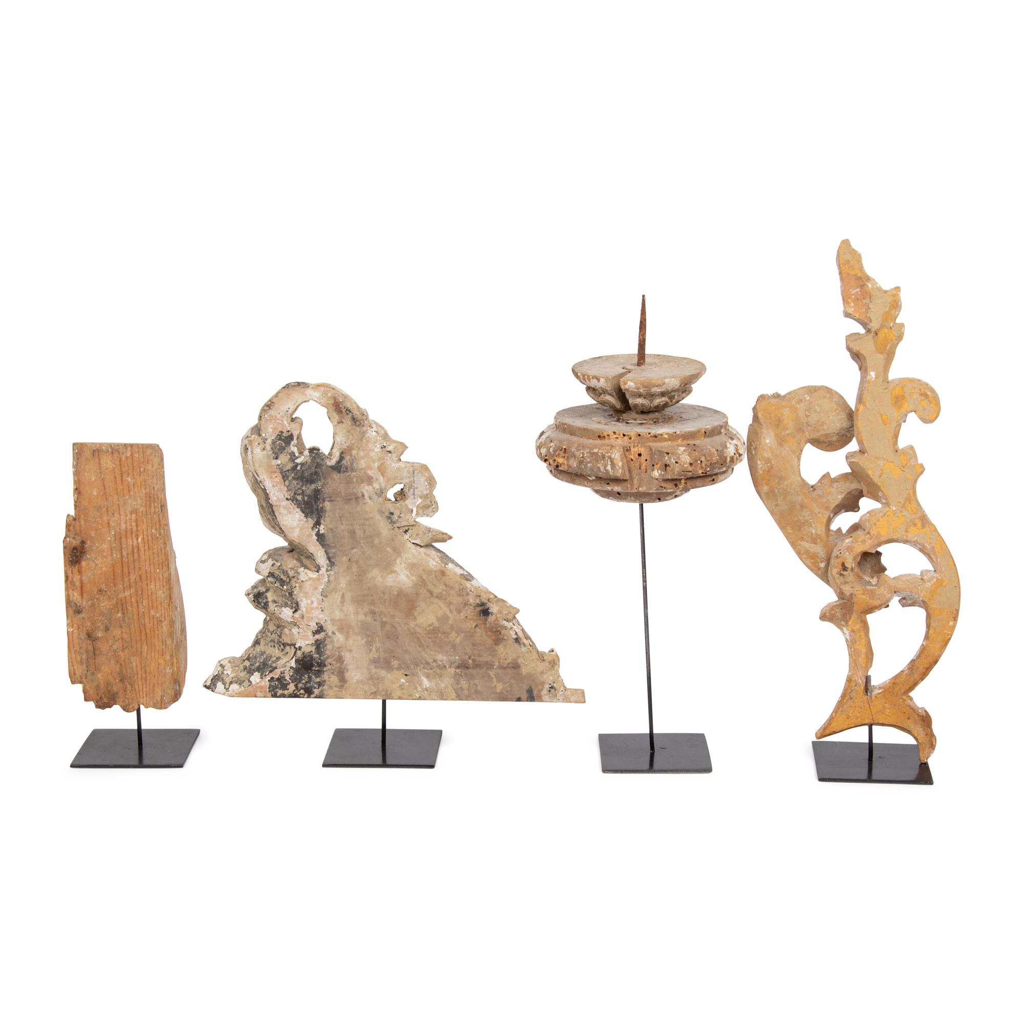 A Group of Four Carved and Painted Wood Fragments on Stands
