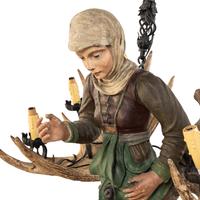 An Austrian Carved Wood and Antler Figural Chandelier