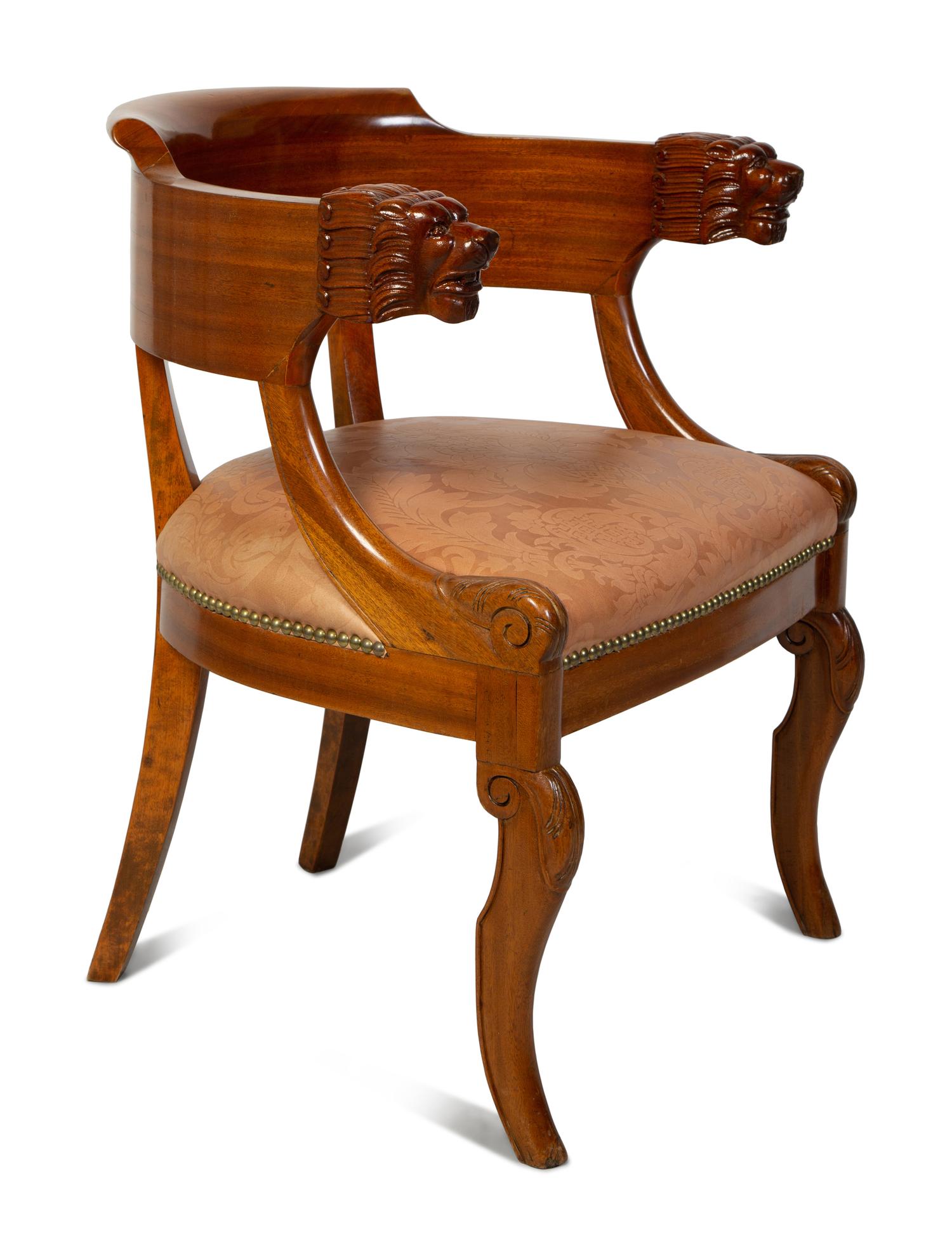 A Regency Style Carved Mahogany Barrel Back Armchair with Lion Head Terminals — 19TH/20TH CENTURY