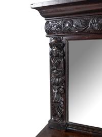 A Jacobean Style Carved Oak Sideboard and Mirror