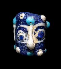 A Phoenician Glass Double-Face Bead