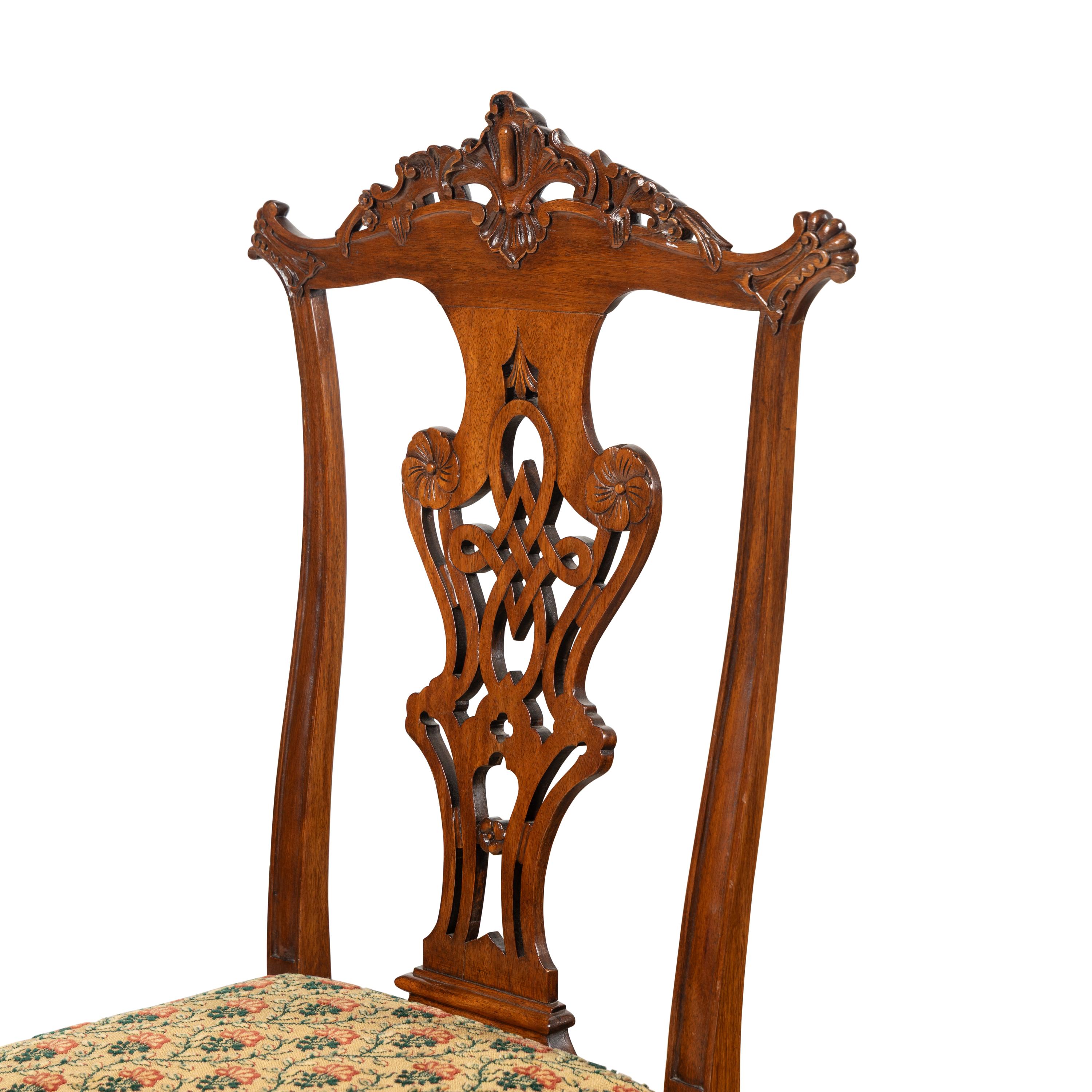 A Set of Four Portuguese Rococo Style Carved Walnut Dining Chairs