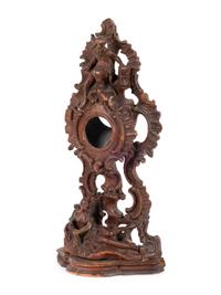 A Continental Rococo Style Carved Fruitwood Watch Stand