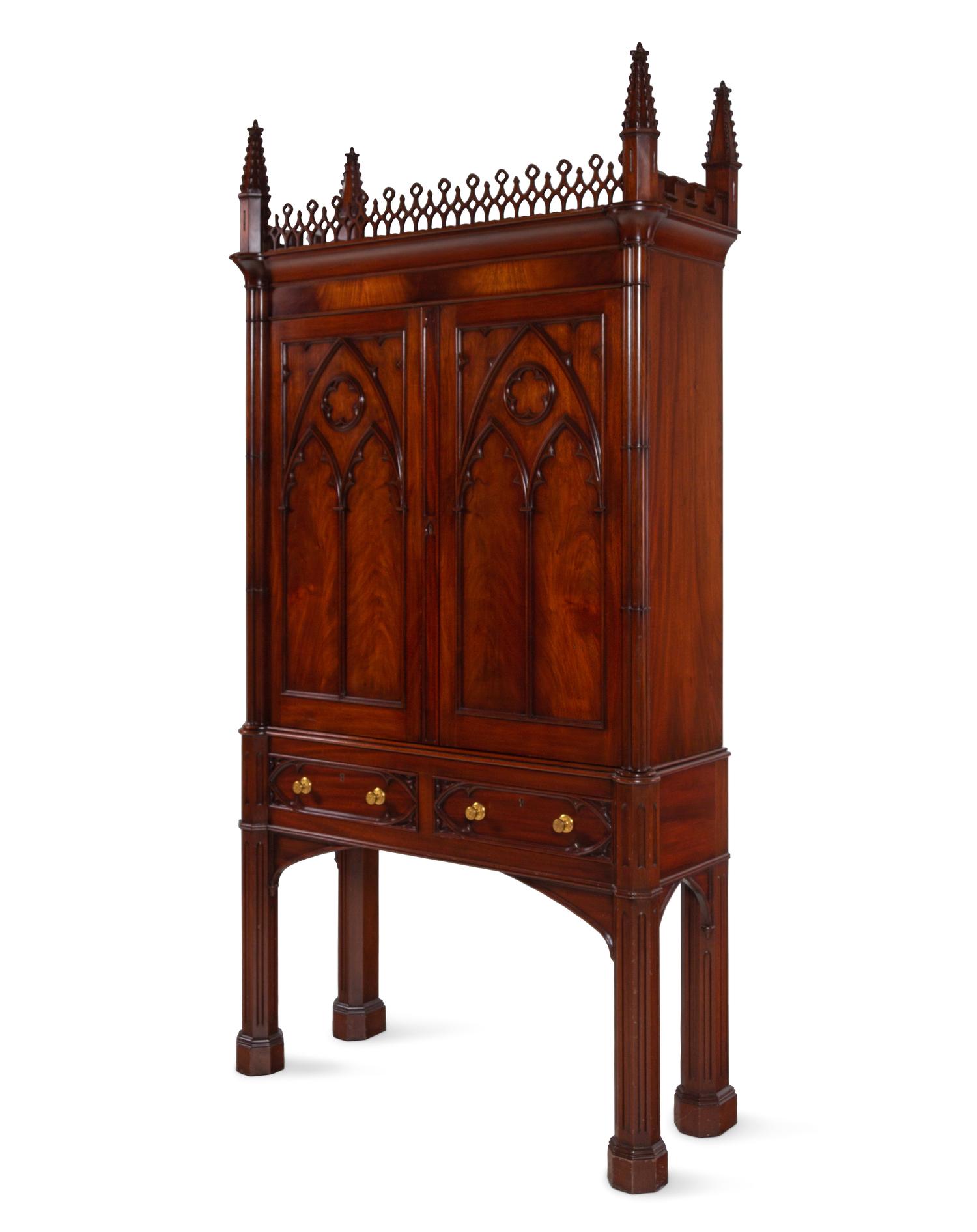 A Gothic Style Carved Mahogany Cabinet with P.E. Guerin Hardware