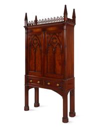A Gothic Style Carved Mahogany Cabinet with P.E. Guerin Hardware