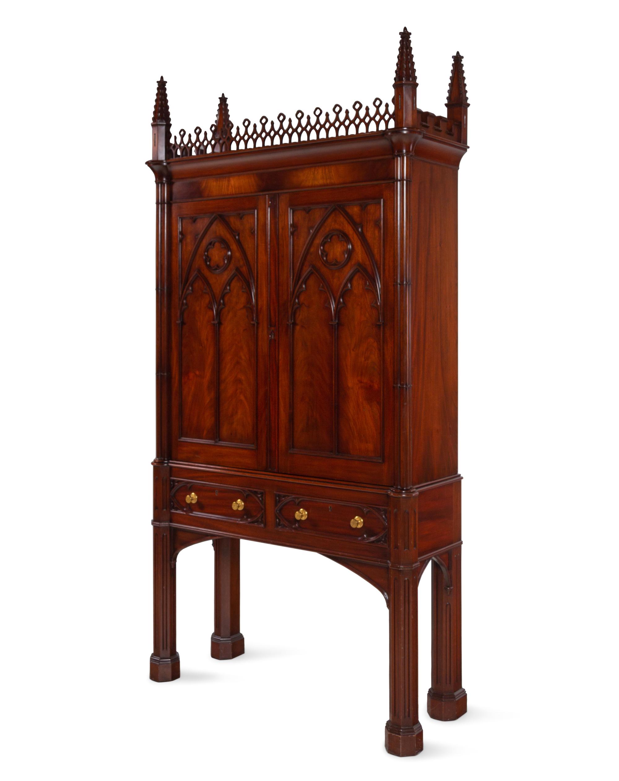 A Gothic Style Carved Mahogany Cabinet with P.E. Guerin Hardware