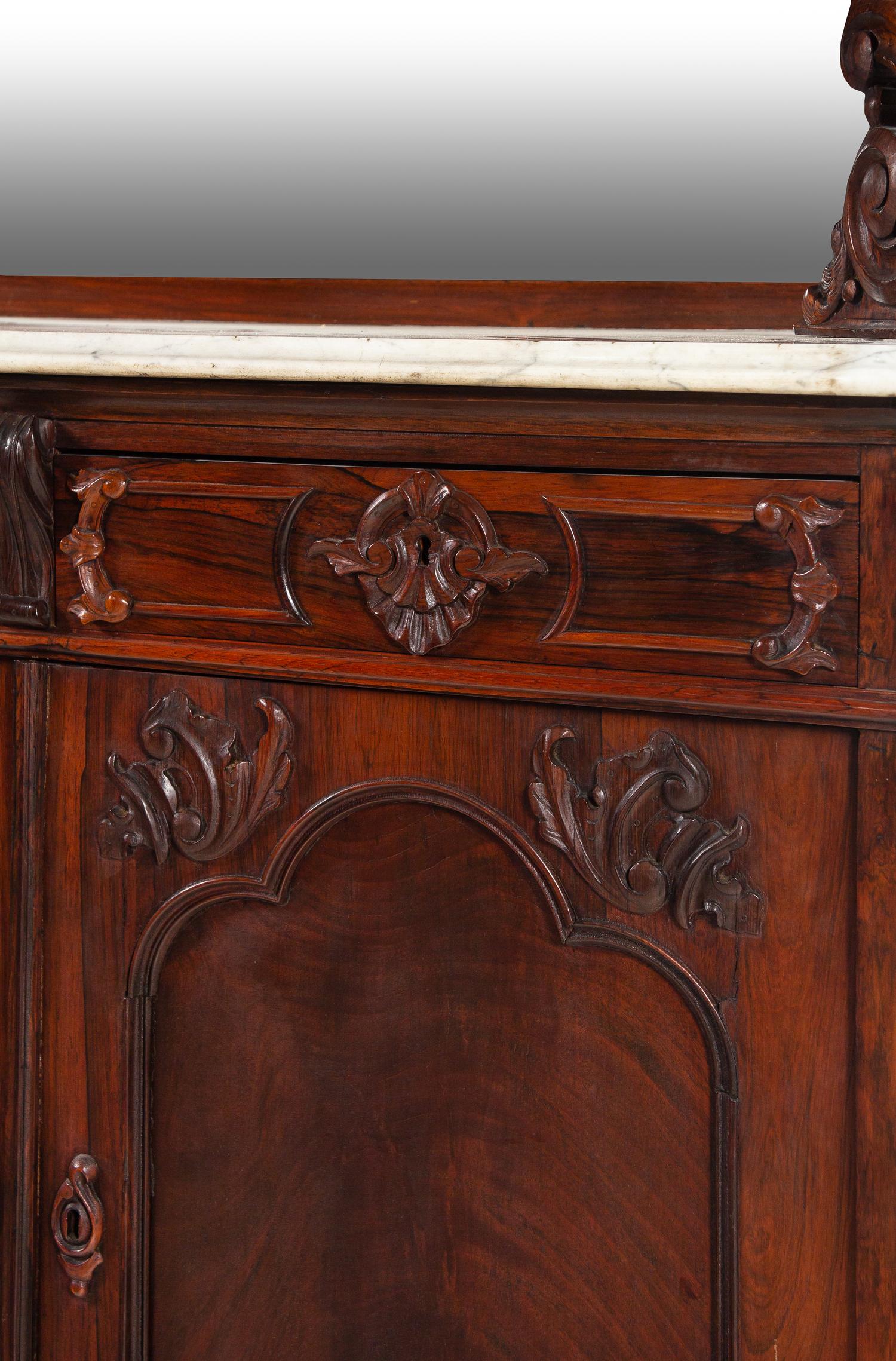 A Rococo Revival Carved Rosewood Marble-Top Serving Cabinet