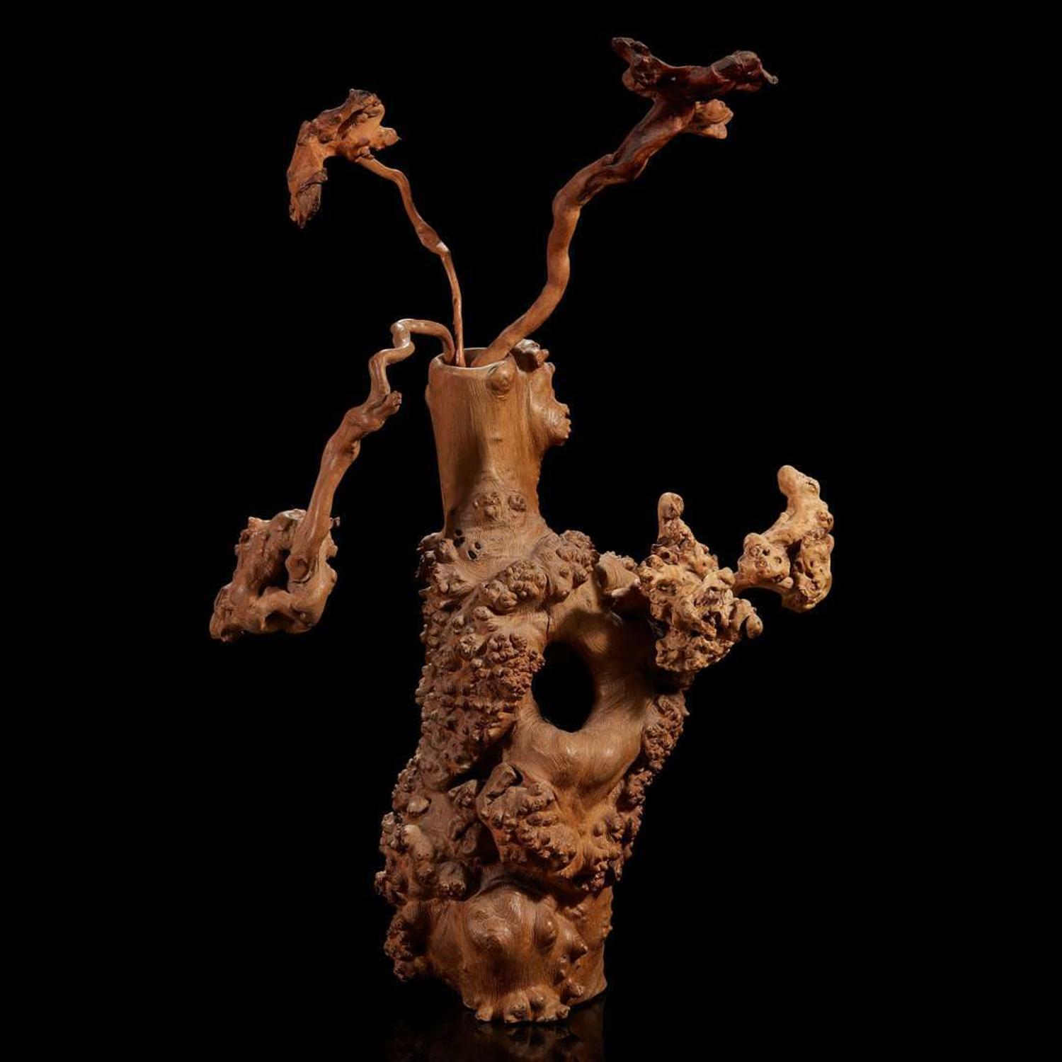 A burl wood vase of "Flowers"