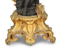 A Pair of Louis XV Style Gilt and Patinated Bronze Figural Six-Light Candelabra