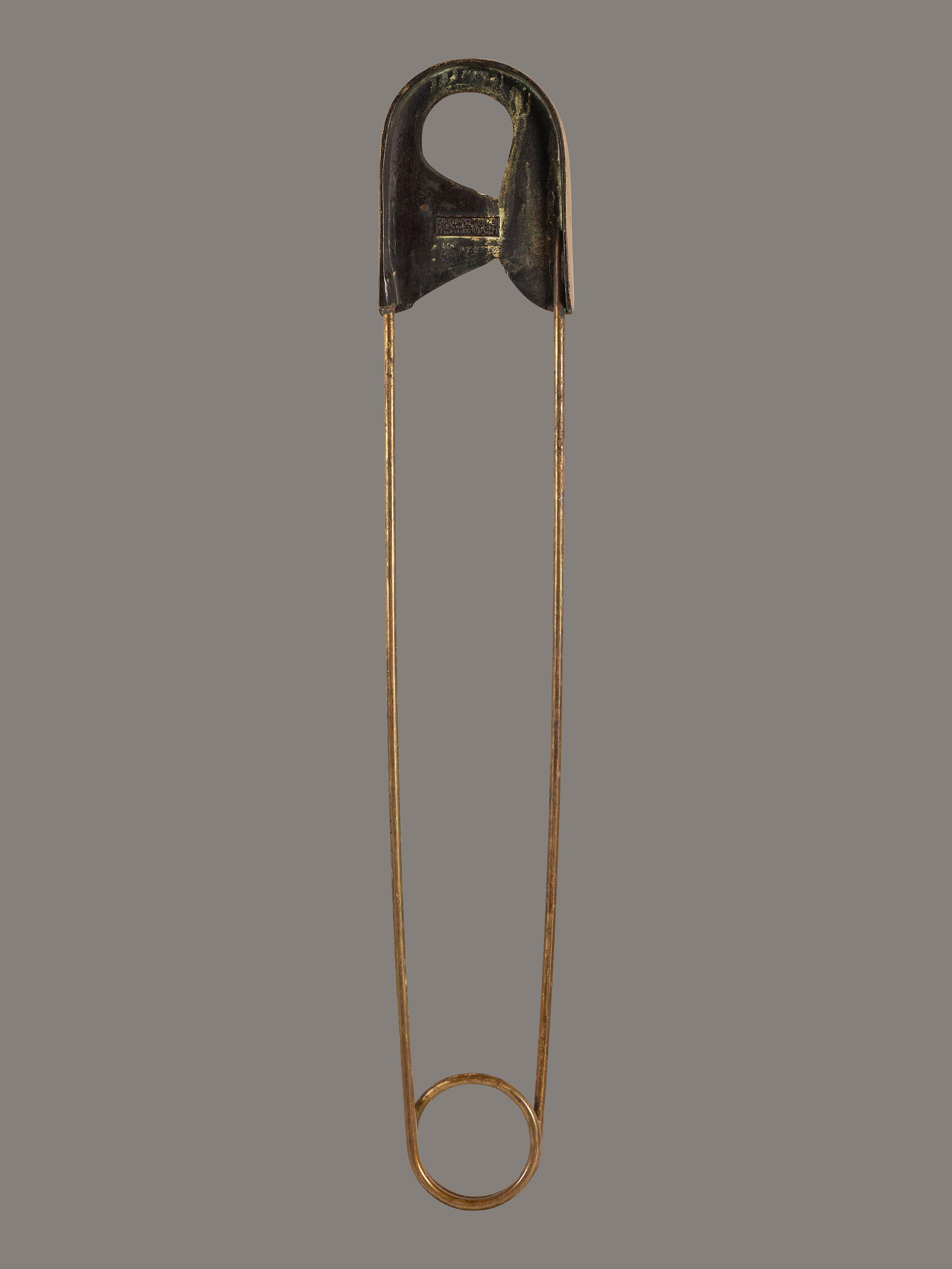 A Gold Painted Bronze Safety Pin Shop Sign