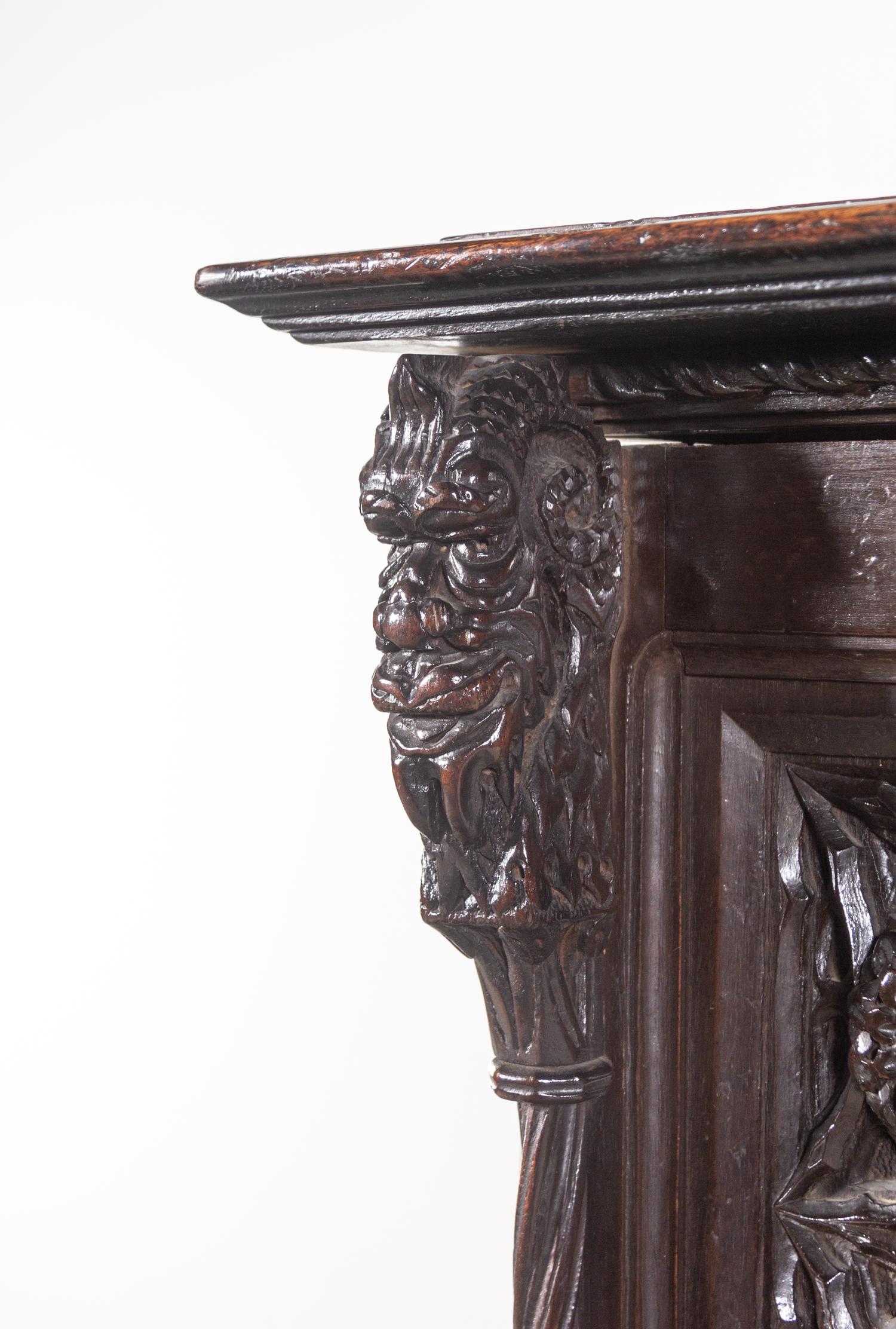 A Gothic Revival Carved Walnut Cabinet on Stand