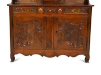 A French Provincial Carved Walnut Clock-Inset Vaissellier
