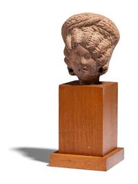 An Egyptian Terracotta Head of a Woman