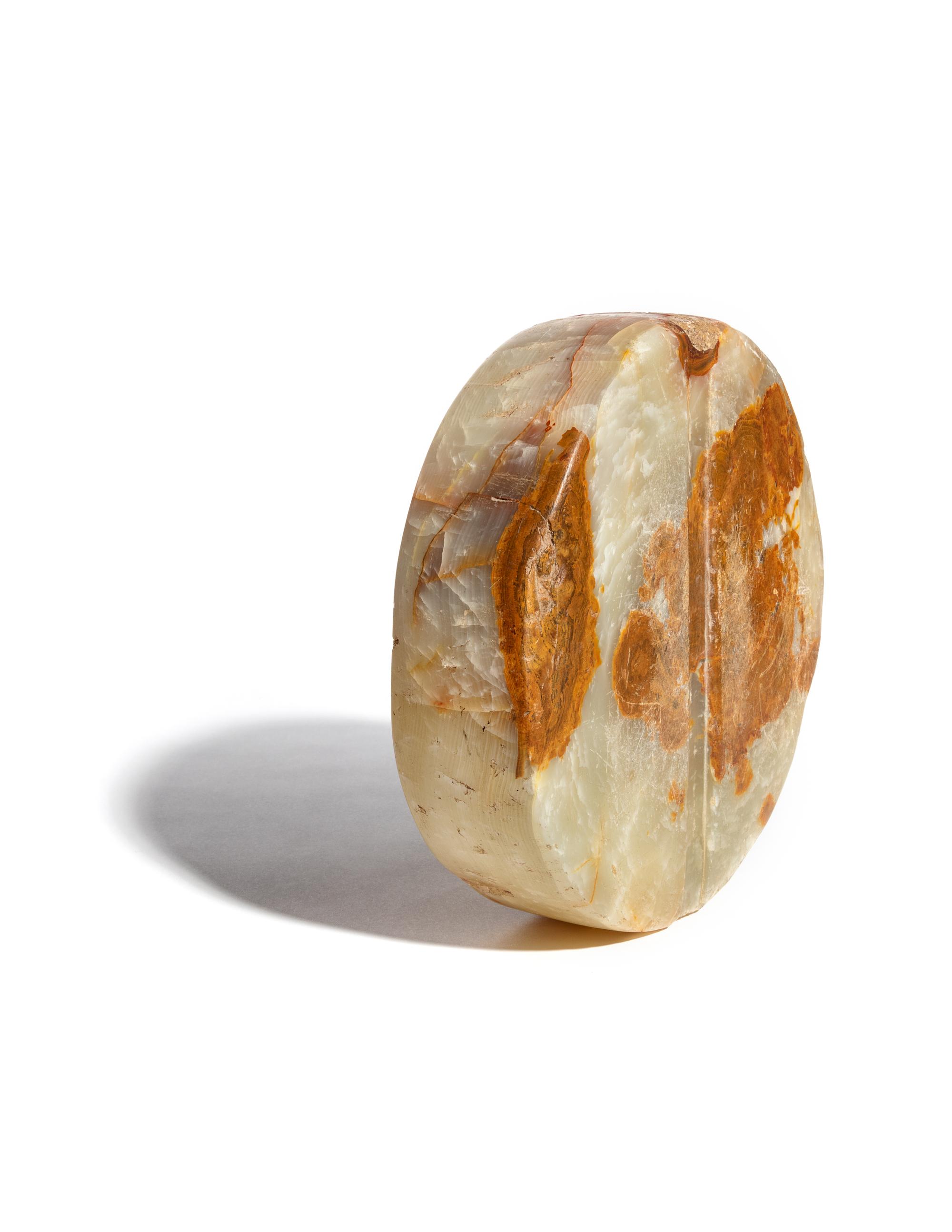 A Bactrian Mottled Green-Orange Stone Disk Ritual Object