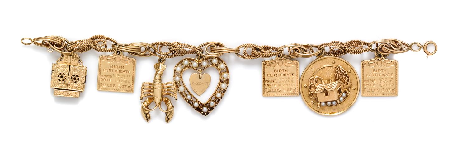 A 14 Karat Yellow Gold Charm Bracelet with 7 Attached Charms, 29.50 dwts.