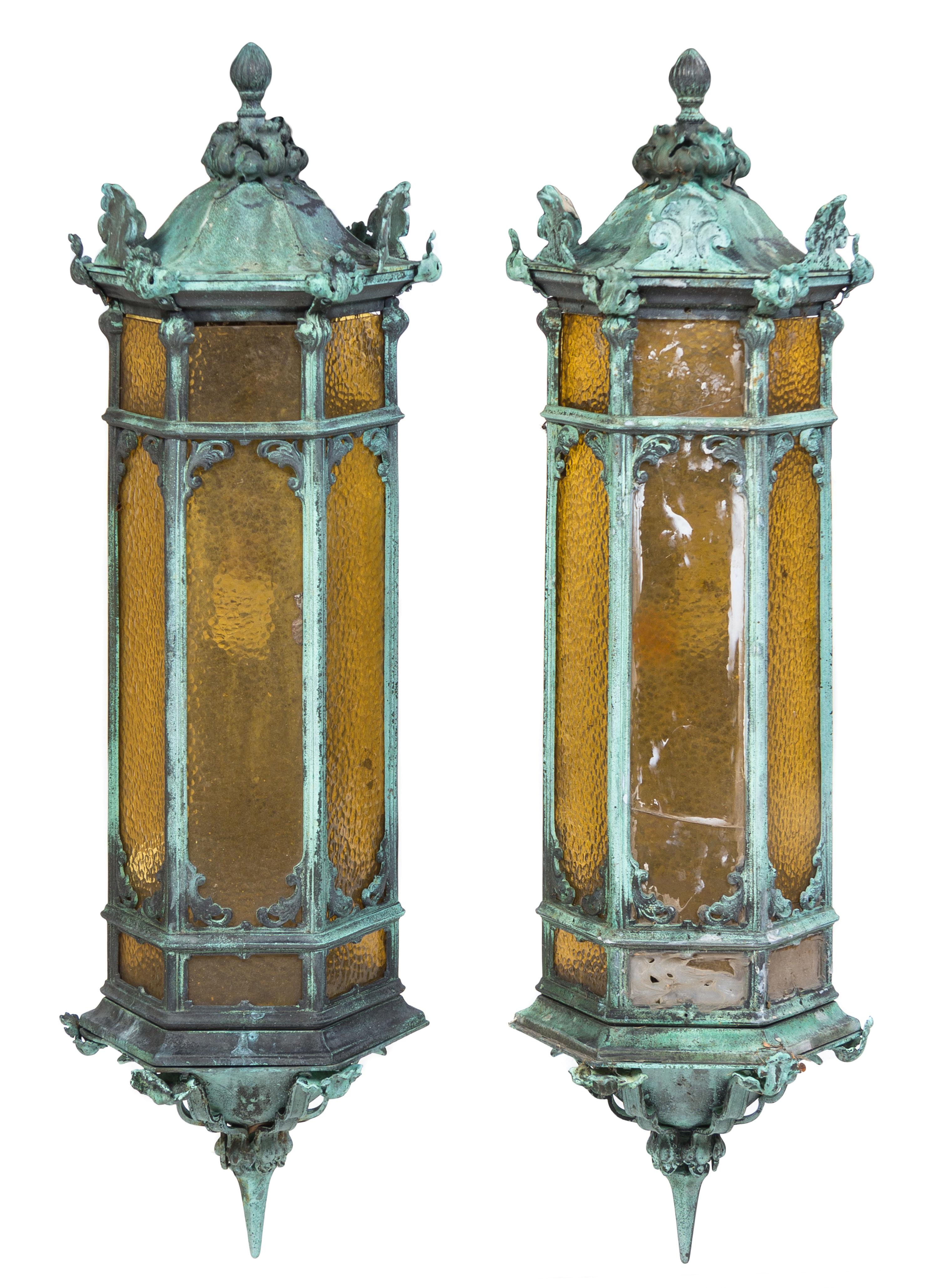 A Pair of Patinated Cast Metal Lanterns Height 35 inches.