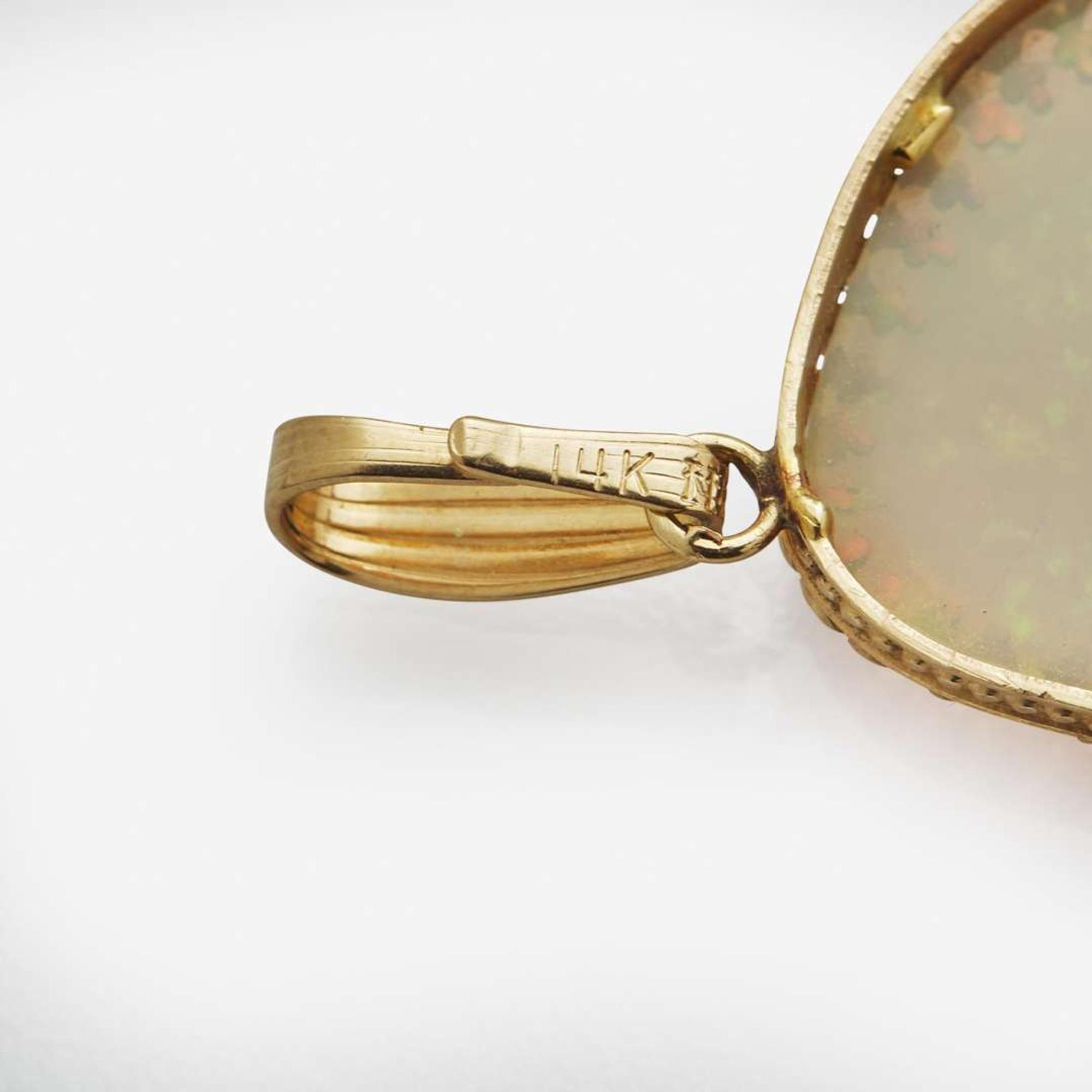 A Collection of Three 14K Yellow Gold and Gemstone Pendants