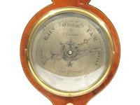 A Regency Brass Mounted and Banded Mahogany Wheel Barometer