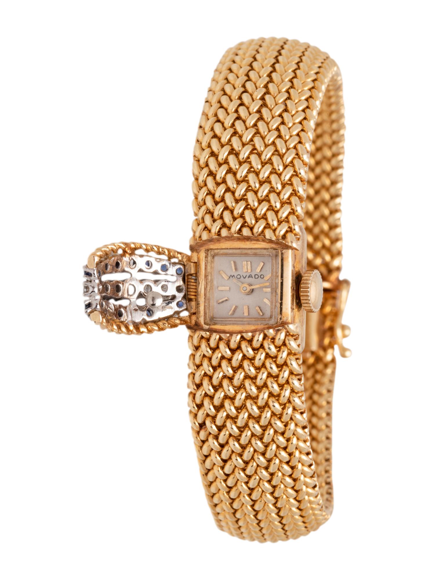 MOVADO, 14K YELLOW GOLD, DIAMOND AND SAPPHIRE SURPRISE WRISTWATCH