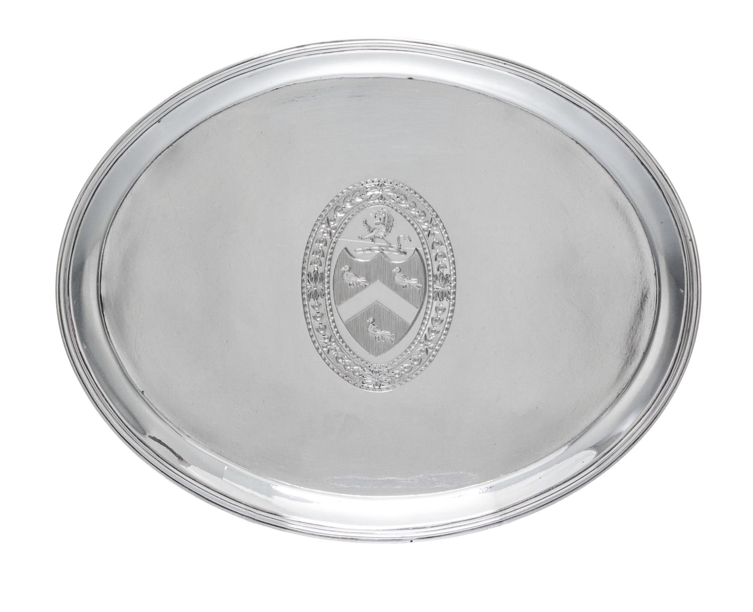 A George III Silver Stand, Hester Bateman, London, 1788, of oval form, having a central oval cartouche with an armorial depicting a lio
