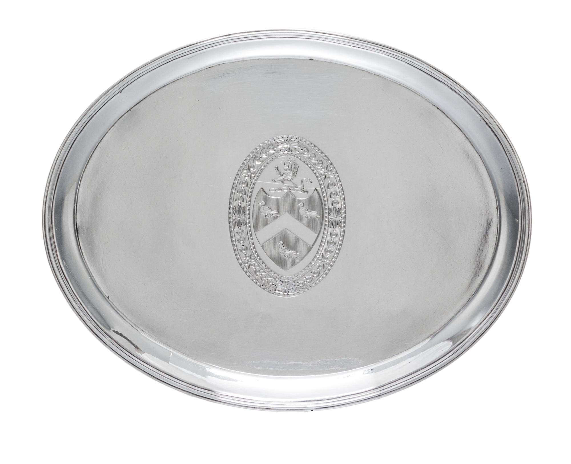 A George III Silver Stand, Hester Bateman, London, 1788, of oval form, having a central oval cartouche with an armorial depicting a lio