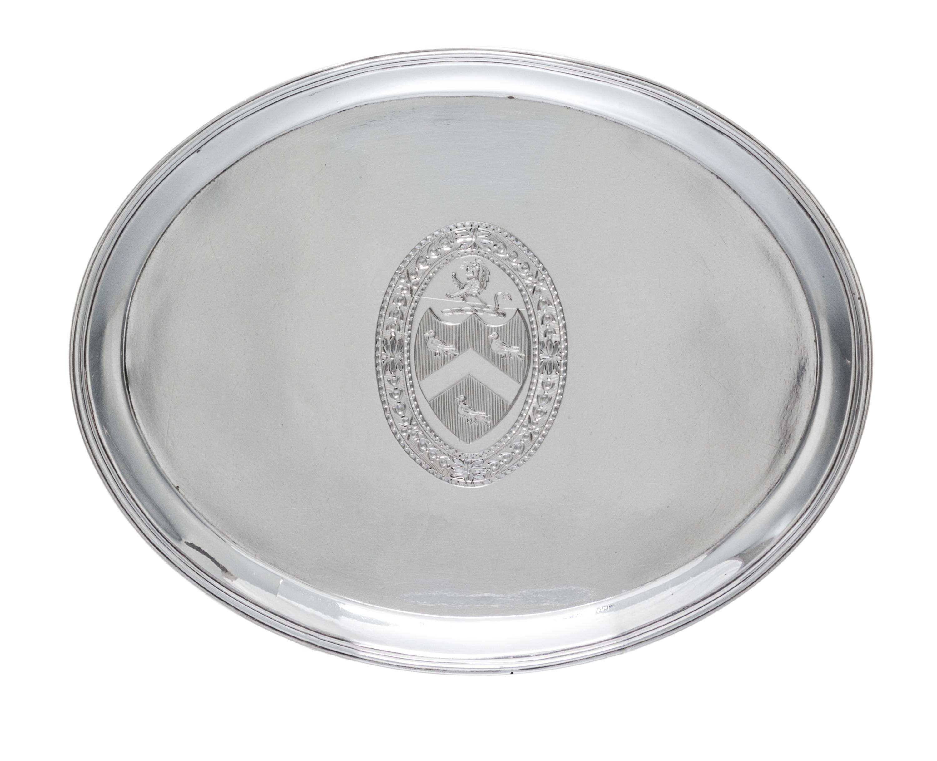A George III Silver Stand, Hester Bateman, London, 1788, of oval form, having a central oval cartouche with an armorial depicting a lio