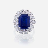 A sapphire, diamond, and fourteen karat white gold ring